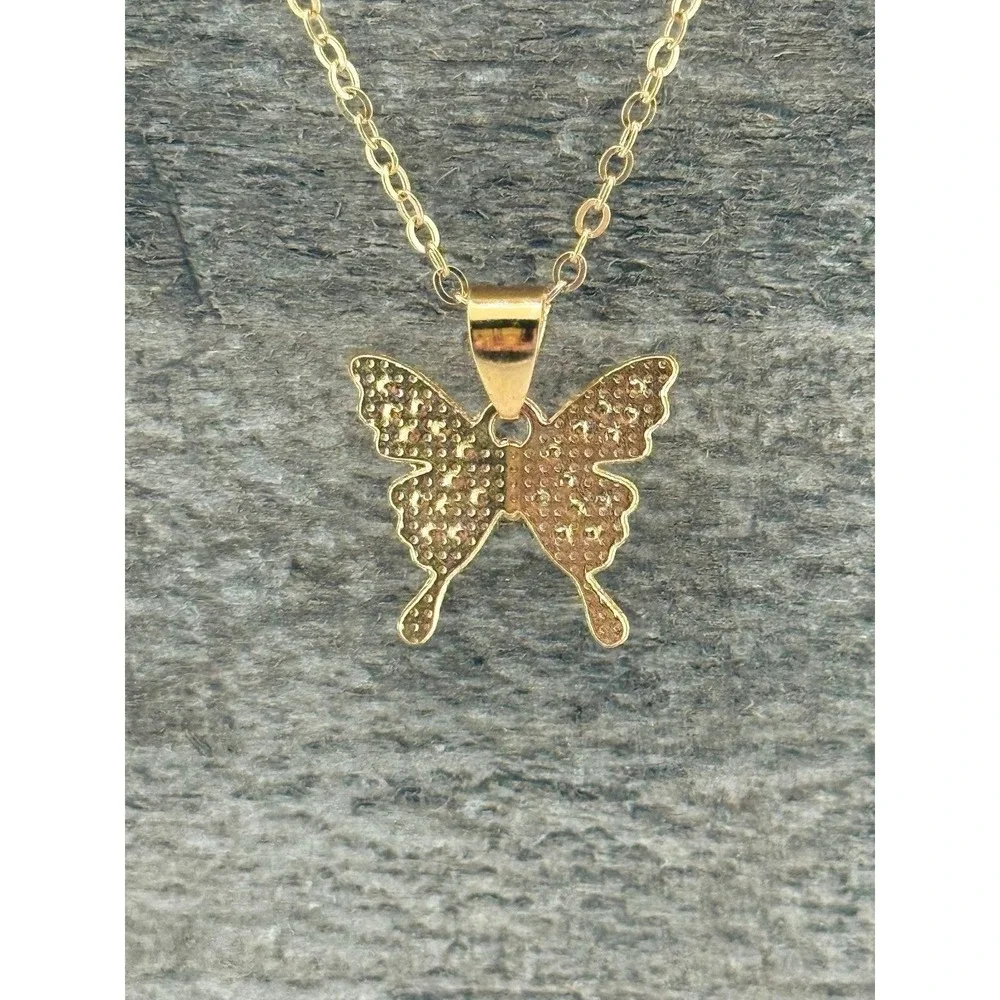 Goldtone butterfly pendant necklace with crystal inlay. 8